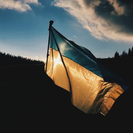 Ukrainian flag flying against a blue sky.