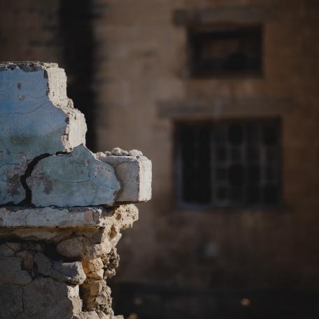 Sinjar, Iraq, image of rubble with building in background